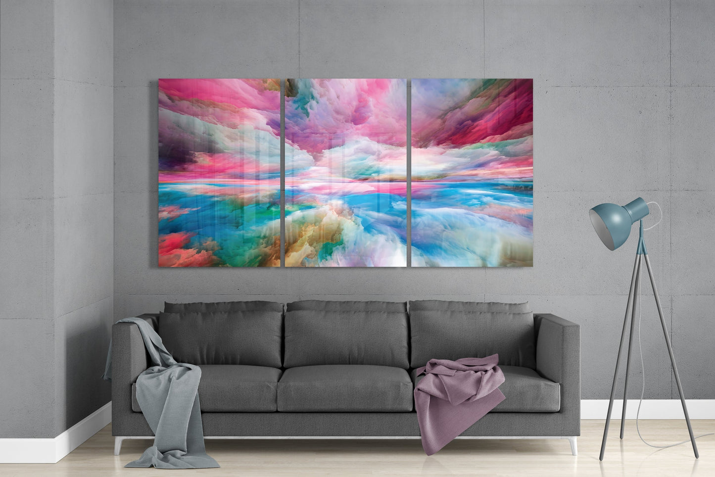 Colorful abstract wall art above a gray sofa in a room with a gray wall.